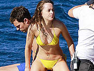 Dakota Johnson in yellow bikini on a yacht