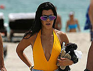 Kourtney Kardashian in swimsuit and shorts