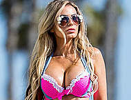 Ana Braga in pink bikini top and denim shorts