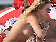 Toni Garrn topless on a beach with friends