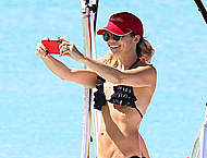 Andrea Corr in bikini on a beach and boat