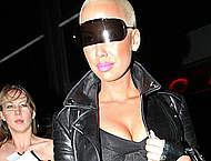 Amber Rose in tight clothing shows cleavage